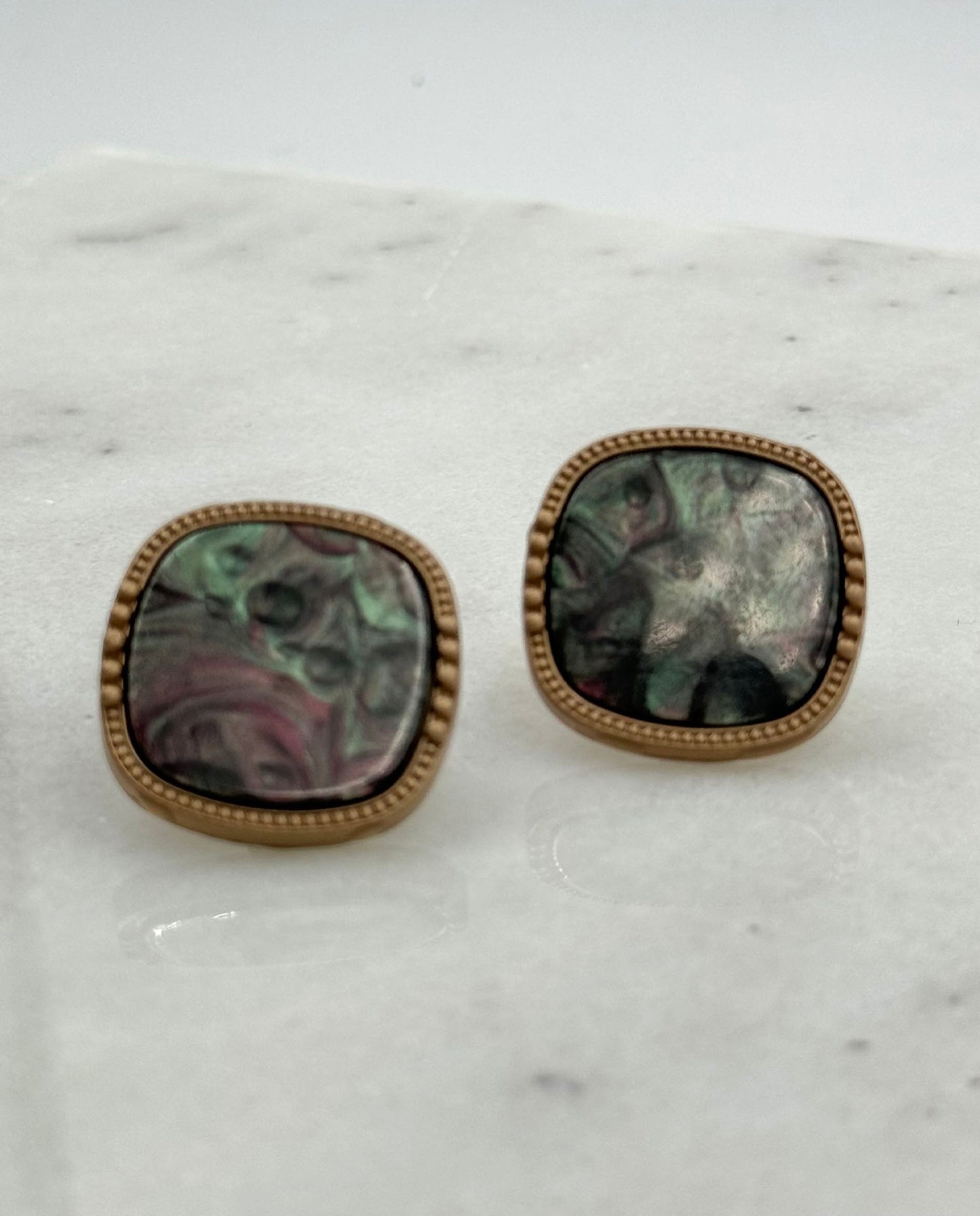 Square-shaped handmade earrings inspired by the colors of the rainbow. Crafted from repurposed buttons, Each piece is one-of-a-kind, celebrating creativity and sustainability.