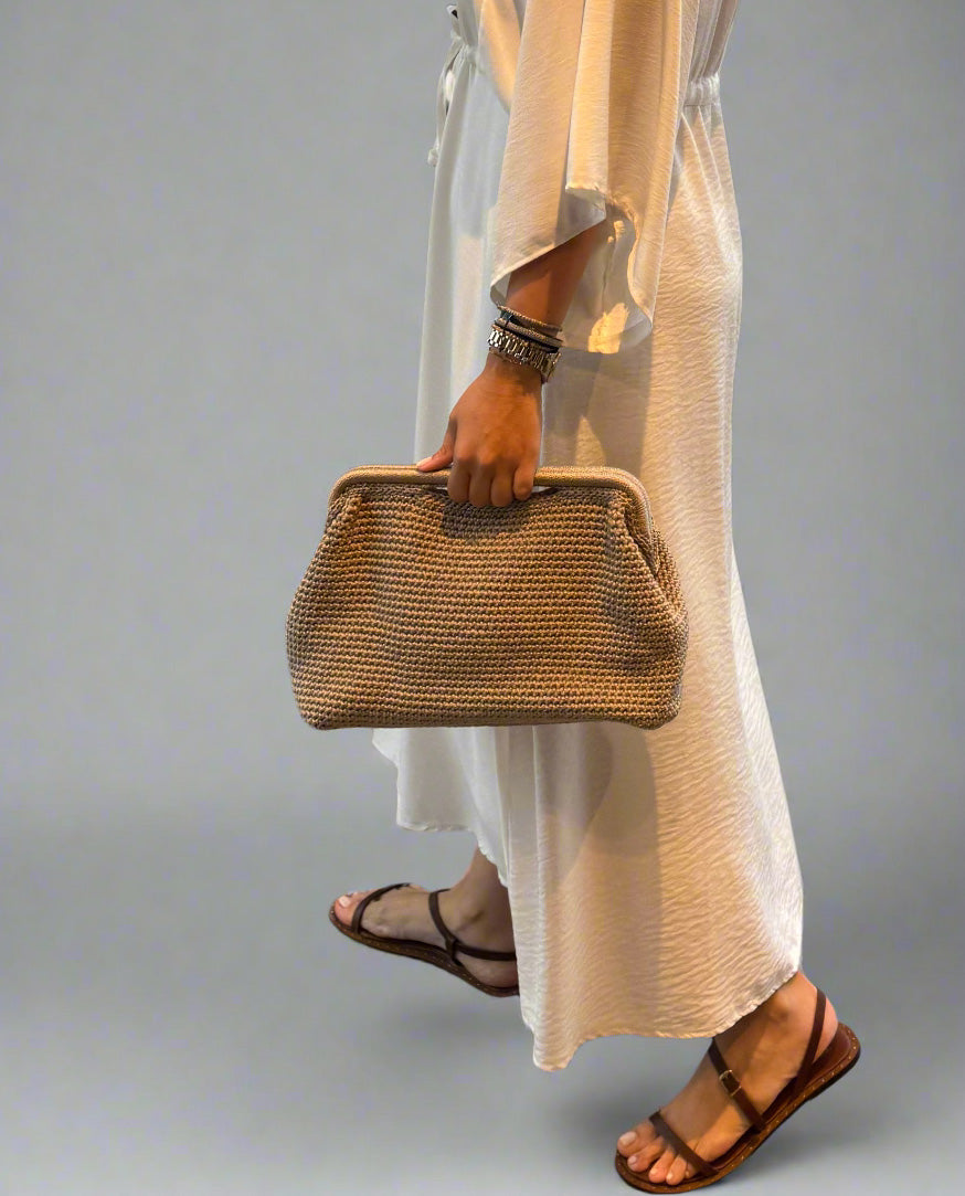 Handmade clutch bag with metal frame and subtle grip cutout – modern, elegant and practical design for day to night looks.